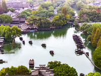 Tourists play at a scenic spot in Wuzhen, Zhejiang province, China, on November 16, 2024. (