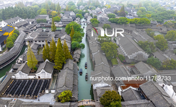 Tourists play at a scenic spot in Wuzhen, Zhejiang province, China, on November 16, 2024. 