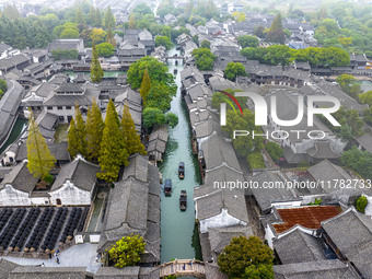 Tourists play at a scenic spot in Wuzhen, Zhejiang province, China, on November 16, 2024. (