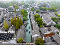 Tourists play at a scenic spot in Wuzhen, Zhejiang province, China, on November 16, 2024. (