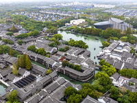 Tourists play at a scenic spot in Wuzhen, Zhejiang province, China, on November 16, 2024. (