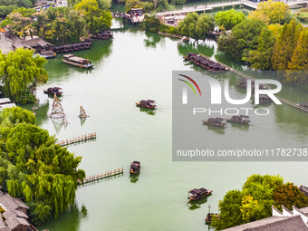 Tourists play at a scenic spot in Wuzhen, Zhejiang province, China, on November 16, 2024. (