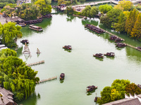 Tourists play at a scenic spot in Wuzhen, Zhejiang province, China, on November 16, 2024. (