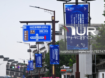 Flags of the World Internet Conference 2024 are seen on a street in Wuzhen, Zhejiang province, China, on November 16, 2024. (