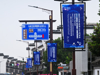 Flags of the World Internet Conference 2024 are seen on a street in Wuzhen, Zhejiang province, China, on November 16, 2024. (