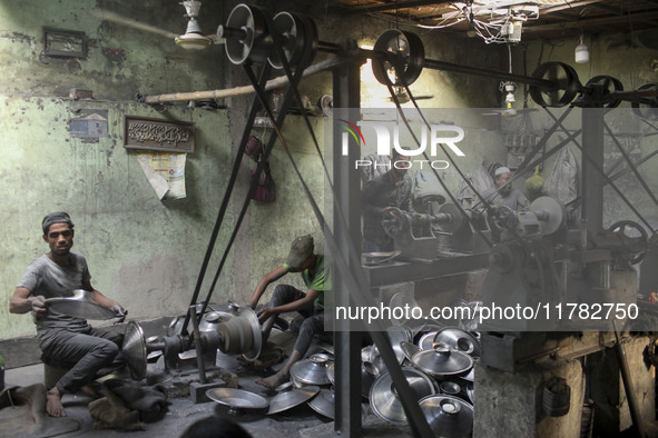 Laborers work inside an aluminum factory in Kamrangirchar, Dhaka, Bangladesh, on November 16, 2024. 