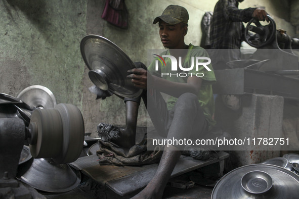 A laborer works inside an aluminum factory in Kamrangirchar, Dhaka, Bangladesh, on November 16, 2024. 