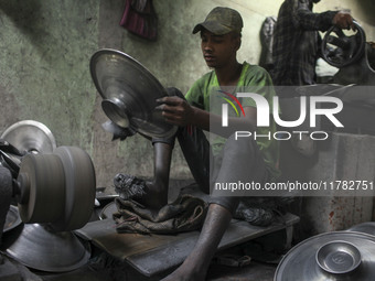 A laborer works inside an aluminum factory in Kamrangirchar, Dhaka, Bangladesh, on November 16, 2024. (