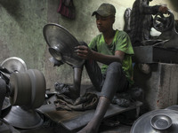 A laborer works inside an aluminum factory in Kamrangirchar, Dhaka, Bangladesh, on November 16, 2024. (