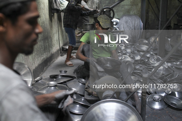 Laborers work inside an aluminum factory in Kamrangirchar, Dhaka, Bangladesh, on November 16, 2024. 