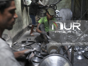 Laborers work inside an aluminum factory in Kamrangirchar, Dhaka, Bangladesh, on November 16, 2024. (