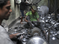 Laborers work inside an aluminum factory in Kamrangirchar, Dhaka, Bangladesh, on November 16, 2024. (