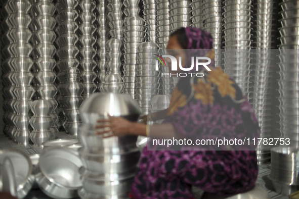 A woman works inside an aluminum factory in Kamrangirchar, Dhaka, Bangladesh, on November 16, 2024. 