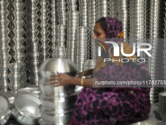 A woman works inside an aluminum factory in Kamrangirchar, Dhaka, Bangladesh, on November 16, 2024. (