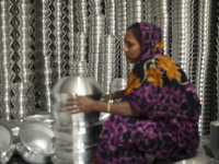 A woman works inside an aluminum factory in Kamrangirchar, Dhaka, Bangladesh, on November 16, 2024. (