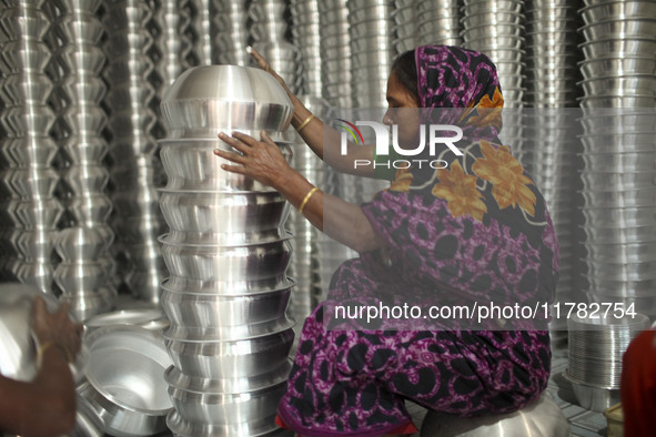 A woman works inside an aluminum factory in Kamrangirchar, Dhaka, Bangladesh, on November 16, 2024. 