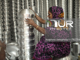 A woman works inside an aluminum factory in Kamrangirchar, Dhaka, Bangladesh, on November 16, 2024. (