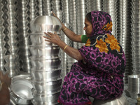 A woman works inside an aluminum factory in Kamrangirchar, Dhaka, Bangladesh, on November 16, 2024. (