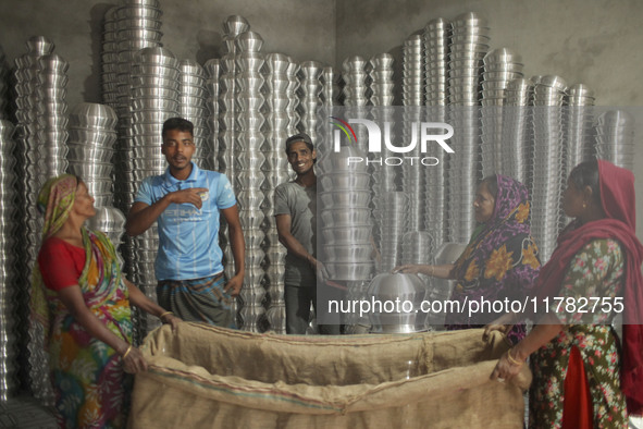 Laborers work inside an aluminum factory in Kamrangirchar, Dhaka, Bangladesh, on November 16, 2024. 