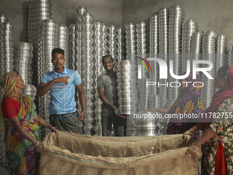 Laborers work inside an aluminum factory in Kamrangirchar, Dhaka, Bangladesh, on November 16, 2024. (