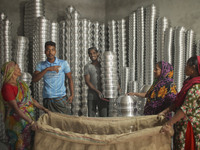 Laborers work inside an aluminum factory in Kamrangirchar, Dhaka, Bangladesh, on November 16, 2024. (