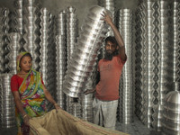 A laborer works inside an aluminum factory in Kamrangirchar, Dhaka, Bangladesh, on November 16, 2024. (