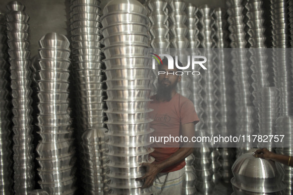 A laborer works inside an aluminum factory in Kamrangirchar, Dhaka, Bangladesh, on November 16, 2024. 