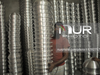 A laborer works inside an aluminum factory in Kamrangirchar, Dhaka, Bangladesh, on November 16, 2024. (