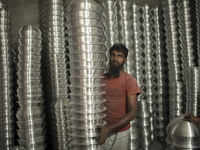 A laborer works inside an aluminum factory in Kamrangirchar, Dhaka, Bangladesh, on November 16, 2024. (