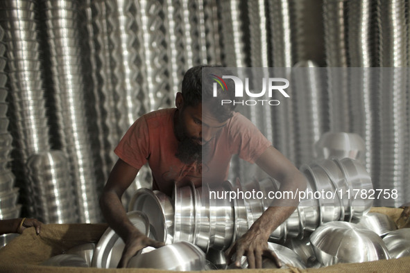 A laborer works inside an aluminum factory in Kamrangirchar, Dhaka, Bangladesh, on November 16, 2024. 