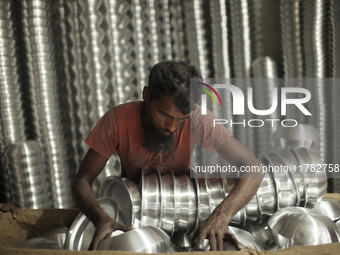 A laborer works inside an aluminum factory in Kamrangirchar, Dhaka, Bangladesh, on November 16, 2024. (