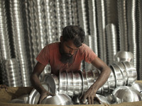 A laborer works inside an aluminum factory in Kamrangirchar, Dhaka, Bangladesh, on November 16, 2024. (