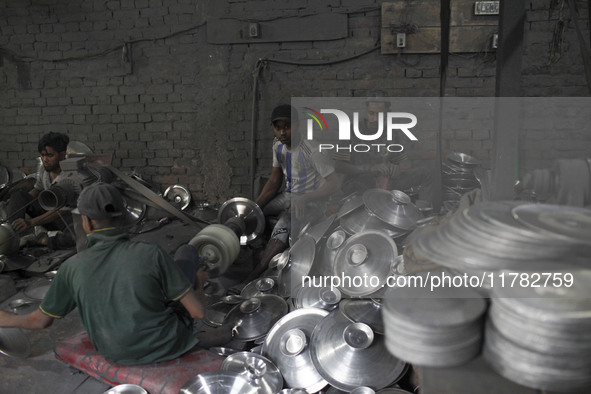 Laborers work inside an aluminum factory in Kamrangirchar, Dhaka, Bangladesh, on November 16, 2024. 