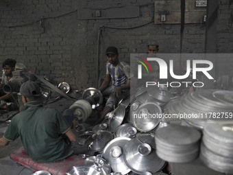 Laborers work inside an aluminum factory in Kamrangirchar, Dhaka, Bangladesh, on November 16, 2024. (