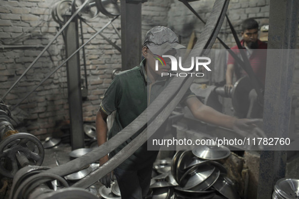 A child laborer works inside an aluminum factory in Kamrangirchar, Dhaka, Bangladesh, on November 16, 2024. 