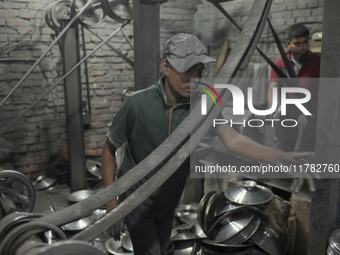 A child laborer works inside an aluminum factory in Kamrangirchar, Dhaka, Bangladesh, on November 16, 2024. (