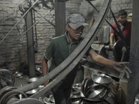 A child laborer works inside an aluminum factory in Kamrangirchar, Dhaka, Bangladesh, on November 16, 2024. (