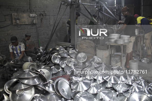 Laborers work inside an aluminum factory in Kamrangirchar, Dhaka, Bangladesh, on November 16, 2024. 