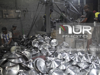 Laborers work inside an aluminum factory in Kamrangirchar, Dhaka, Bangladesh, on November 16, 2024. (