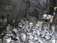 Laborers work inside an aluminum factory in Kamrangirchar, Dhaka, Bangladesh, on November 16, 2024. (