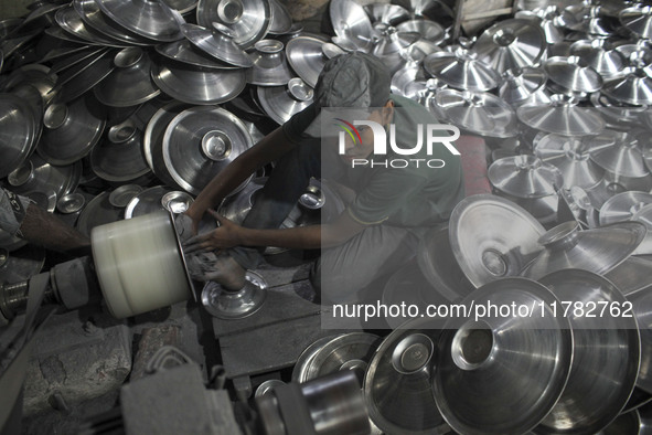 A child laborer works inside an aluminum factory in Kamrangirchar, Dhaka, Bangladesh, on November 16, 2024. 