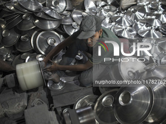 A child laborer works inside an aluminum factory in Kamrangirchar, Dhaka, Bangladesh, on November 16, 2024. (