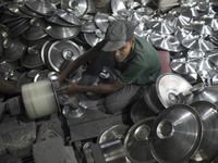 A child laborer works inside an aluminum factory in Kamrangirchar, Dhaka, Bangladesh, on November 16, 2024. (