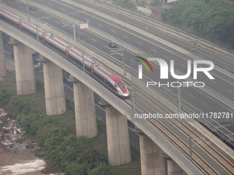 The Jakarta-Bandung high-speed train, also known as Whoosh, is seen crossing Bekasi, West Java, on Saturday, November 16, 2024. Deputy Minis...