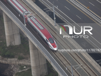 The Jakarta-Bandung high-speed train, also known as Whoosh, is seen crossing Bekasi, West Java, on Saturday, November 16, 2024. Deputy Minis...