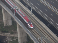 The Jakarta-Bandung high-speed train, also known as Whoosh, is seen crossing Bekasi, West Java, on Saturday, November 16, 2024. Deputy Minis...