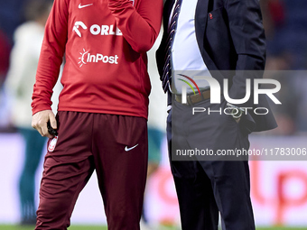 Michal Probierz, Head Coach of Poland, talks with a staff member prior to the UEFA Nations League 2024/25 League A Group A1 match between Po...