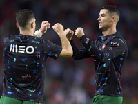 Cristiano Ronaldo of Portugal shakes hands with Diogo Dalot of Portugal before the UEFA Nations League 2024/25 League A Group A1 match betwe...