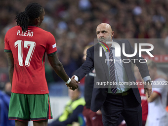 Michal Probierz, Head Coach of Poland, shakes hands with Rafael Leao of Portugal during the UEFA Nations League 2024/25 League A Group A1 ma...