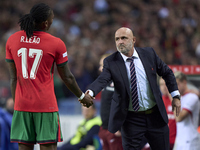 Michal Probierz, Head Coach of Poland, shakes hands with Rafael Leao of Portugal during the UEFA Nations League 2024/25 League A Group A1 ma...